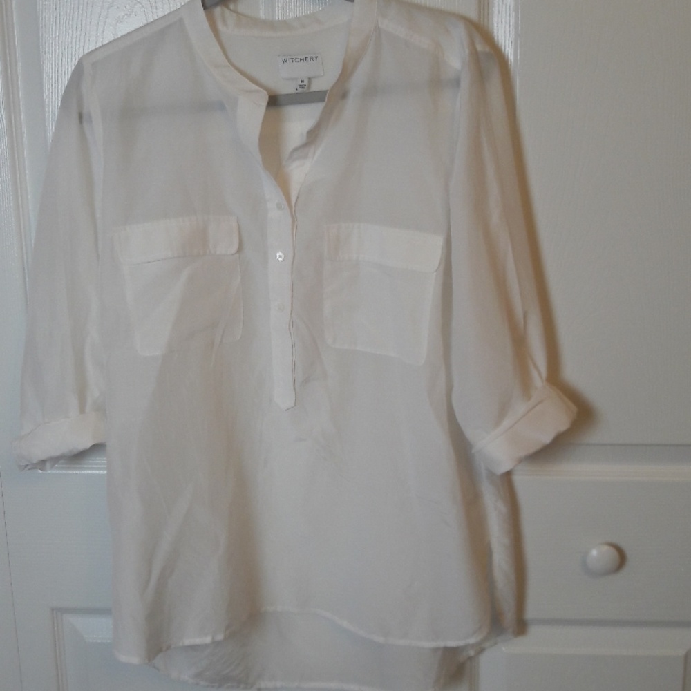 Long sleeved white botton front shirt. NWOT